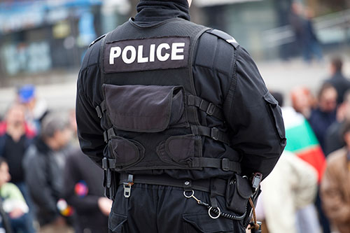 Police Standing in Front of people.